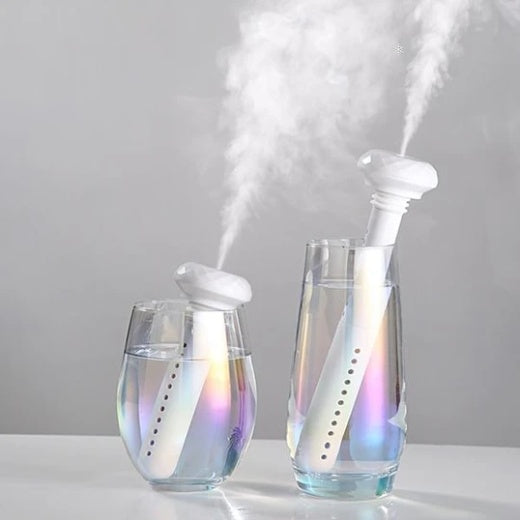 Portable USB Home Silent Mineral Water Humidifier in two glasses misting water for improved air quality.