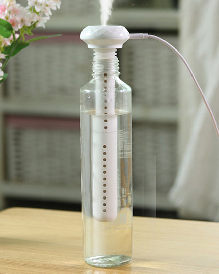 Portable USB Home Silent Mineral Water Humidifier in action, releasing mist from a water bottle.