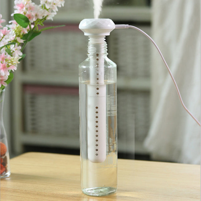 Portable USB Home Silent Mineral Water Humidifier in action, releasing mist from a water bottle.